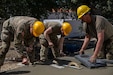 U.S. Army Reserve Soldiers with the 801st Engineer Construction Company work to complete a cement sidewalk entrance to the Wellness Center during the Combat Support Training Exercise at Fort Hunter Liggett, California, on June 11, 2024. CSTX 24-01 is a Combat Support Training Exercise that ensures America’s Army Reserve units and Soldiers are trained and equipped at the scale and speed required to support the joint force, multi-domain operational environment. (photo credit by Cpl. Raymond Benitez)
