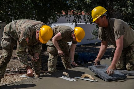 Engineer Soldiers build concrete paths at annual training