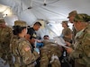 U.S. Army Reserve Soldiers with the 352nd Field Hospital assess a simulated casualty during the multi-national medical training exercise, Global Medic, at Fort Hunter Liggett, California, on June 10, 2024. The Medical Readiness Training Command executes Exercise Global Medic as part of the 807th Medical Command (Deployment Support) and Army Reserve Medical Command's larger mission to deliver relevant and realistic collective training to medical units and Soldiers preparing for large-scale combat operations. (U.S. Army photo by Spc. Midori Preecs)