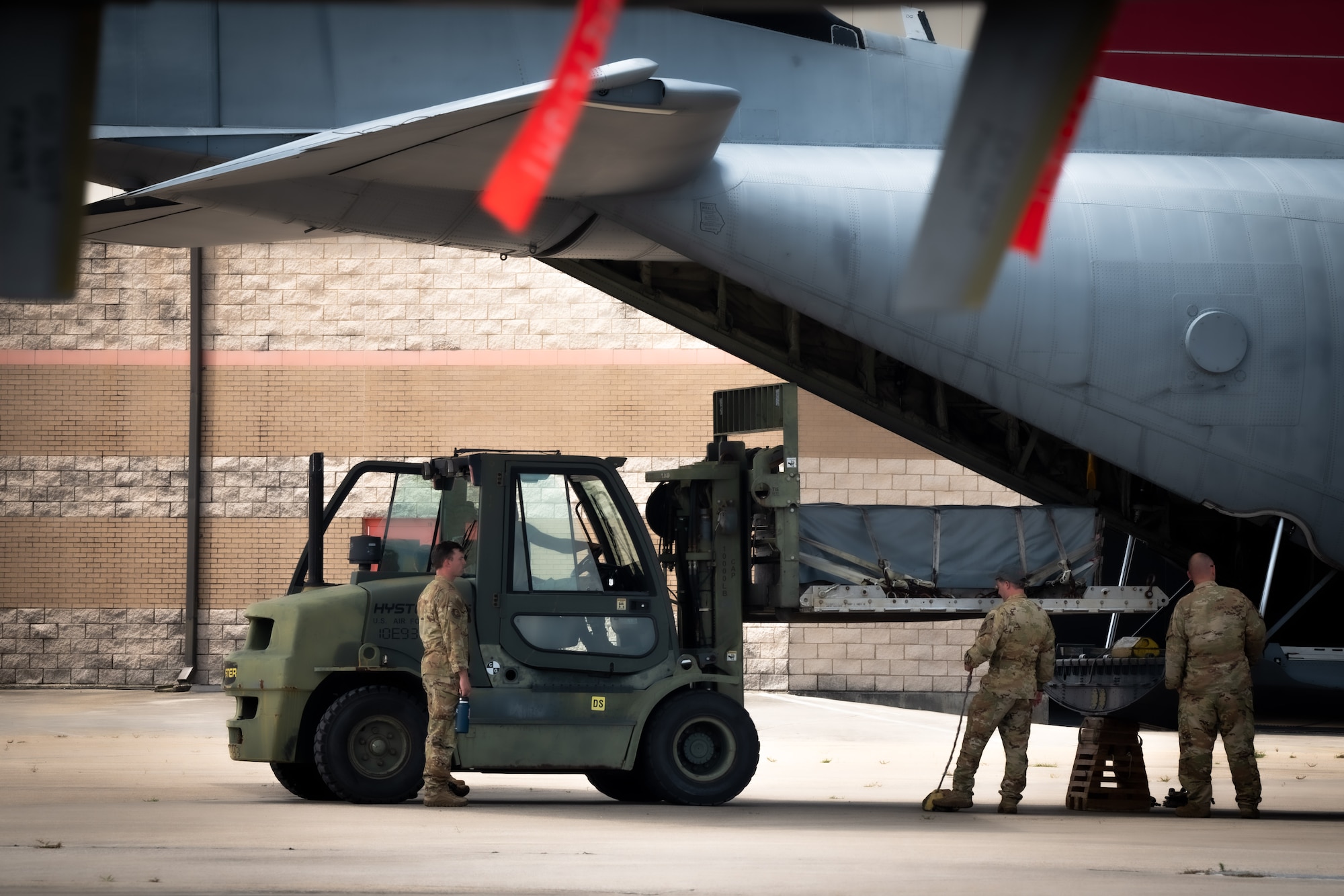 Airmen load a cargo pallet onto a C-130J Super Hercules.