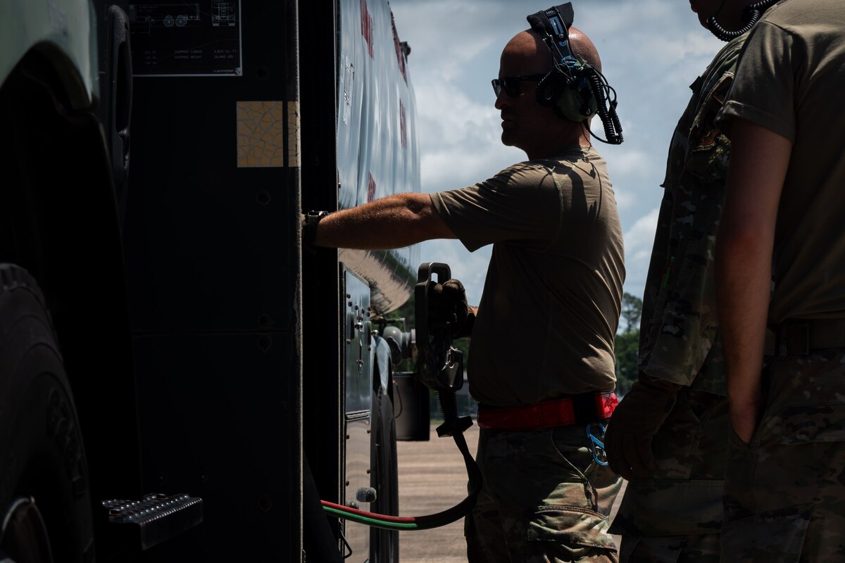 Airmen operate fuel truck to conduct a refueling of a F-15C Eagle aircraft.