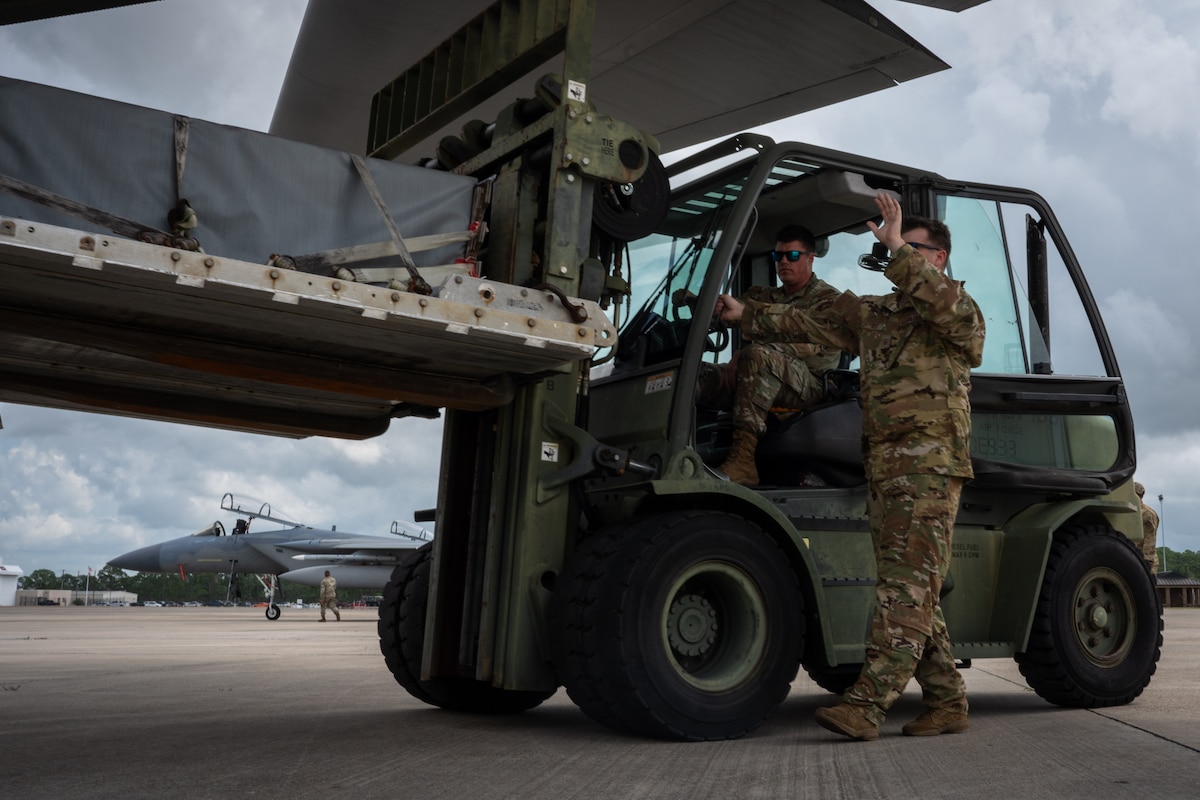 Airmen load a cargo pallet onto a C-130J Super Hercules.