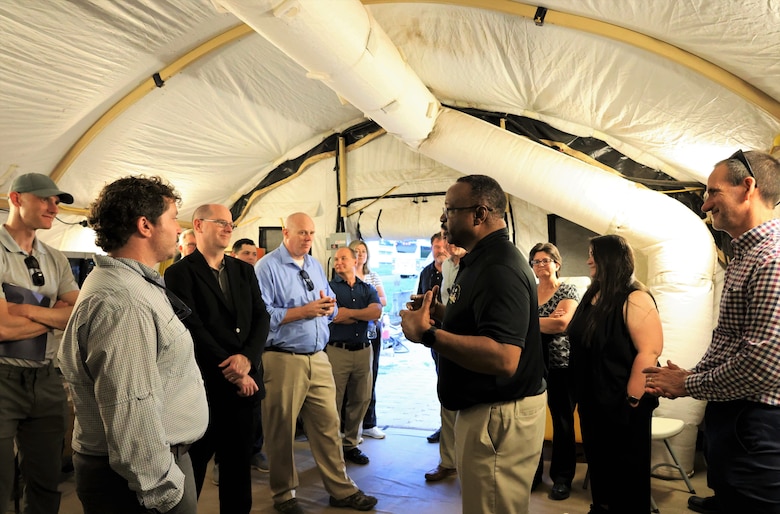 Mark Hammond, Chemical Materials Activity and Chemical, Biological, Radiological, Nuclear, Explosives Analytical and Remediation Activity professional, briefs guests during a tour of a munitions excavation site at Redstone Arsenal, Alabama, June 5.