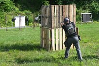 A U.S. Marshal conducts training on a firing range at Fort Indiantown Gap, Pa., June 12, 2024. About 30 U.S. Marshals from around the country conducted training on high-stress scenarios at Fort Indiantown Gap June 3 to 13. (Pennsylvania National Guard photo by Brad Rhen)