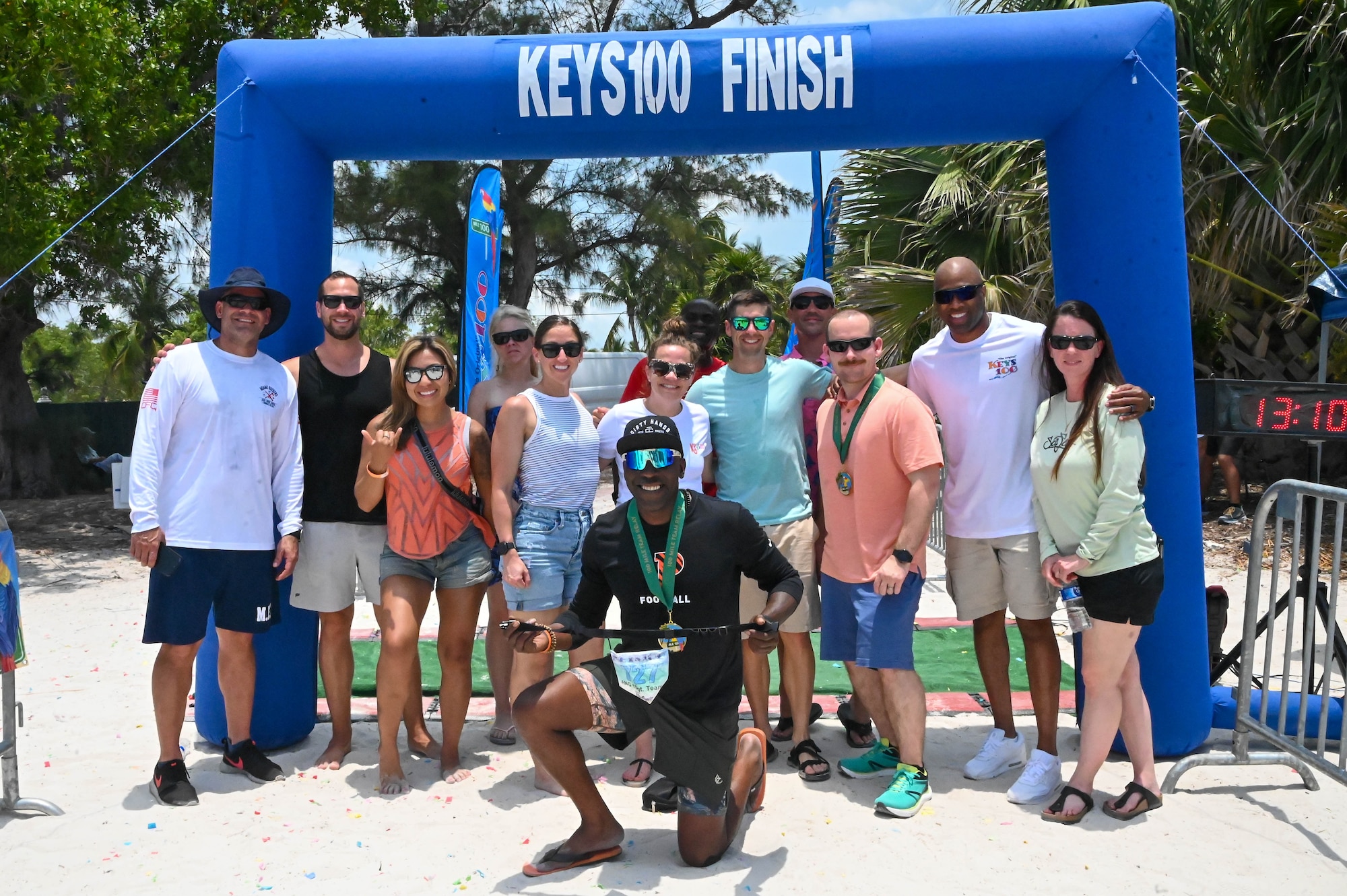 Air National Guard First Sergeants pose at the finish line after completing the Keys 100 Ultramarathon