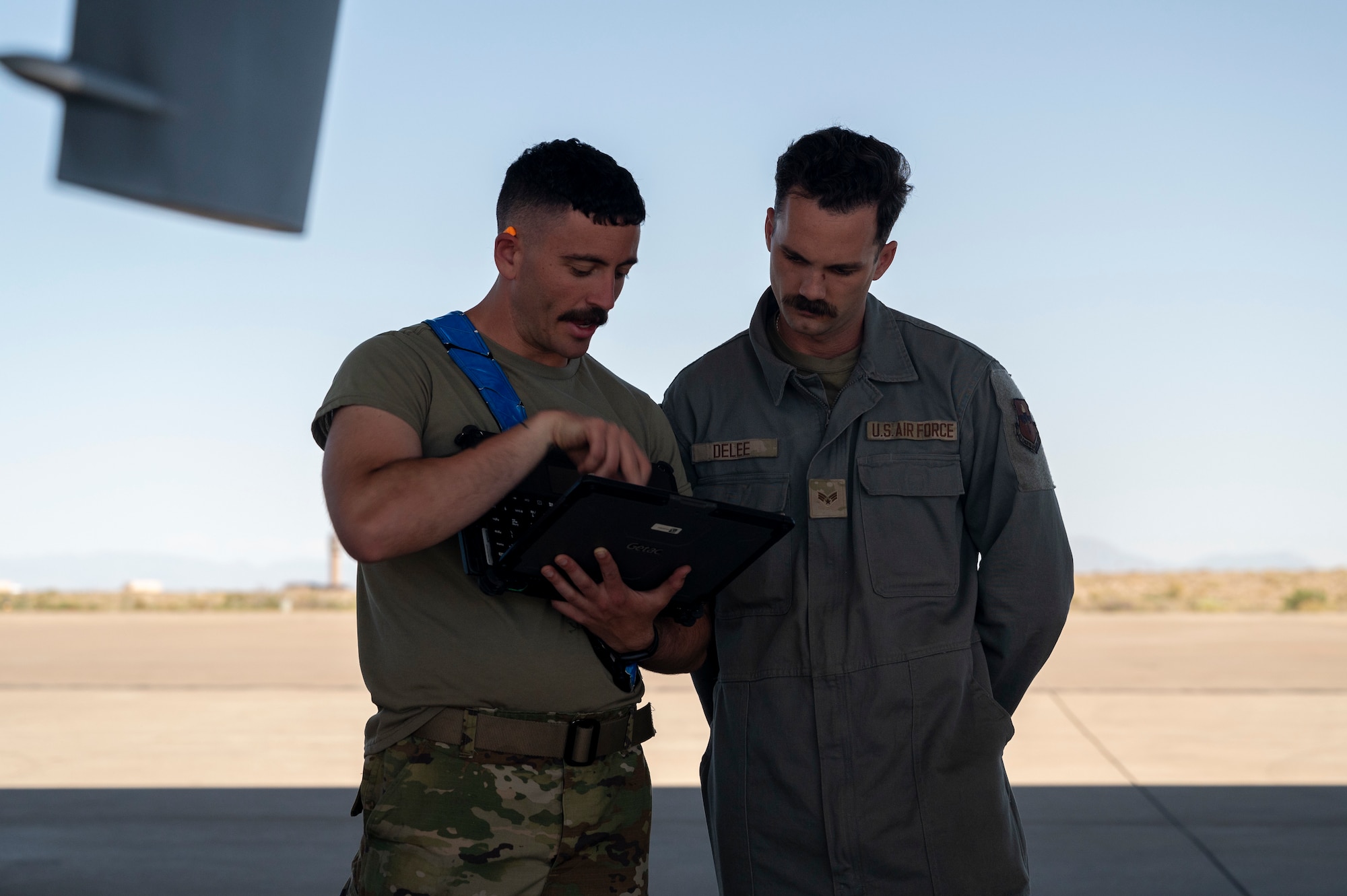 U.S. Air Force Senior Airman Daniel Knight, 49th Aircraft Maintenance Squadron assistant dedicated crew chief, left, reviews technical orders with U.S. Air Force Senior Airman Braden Delee, 49th AMXS crew chief, at Holloman Air Force Base, New Mexico, June 11, 2024.