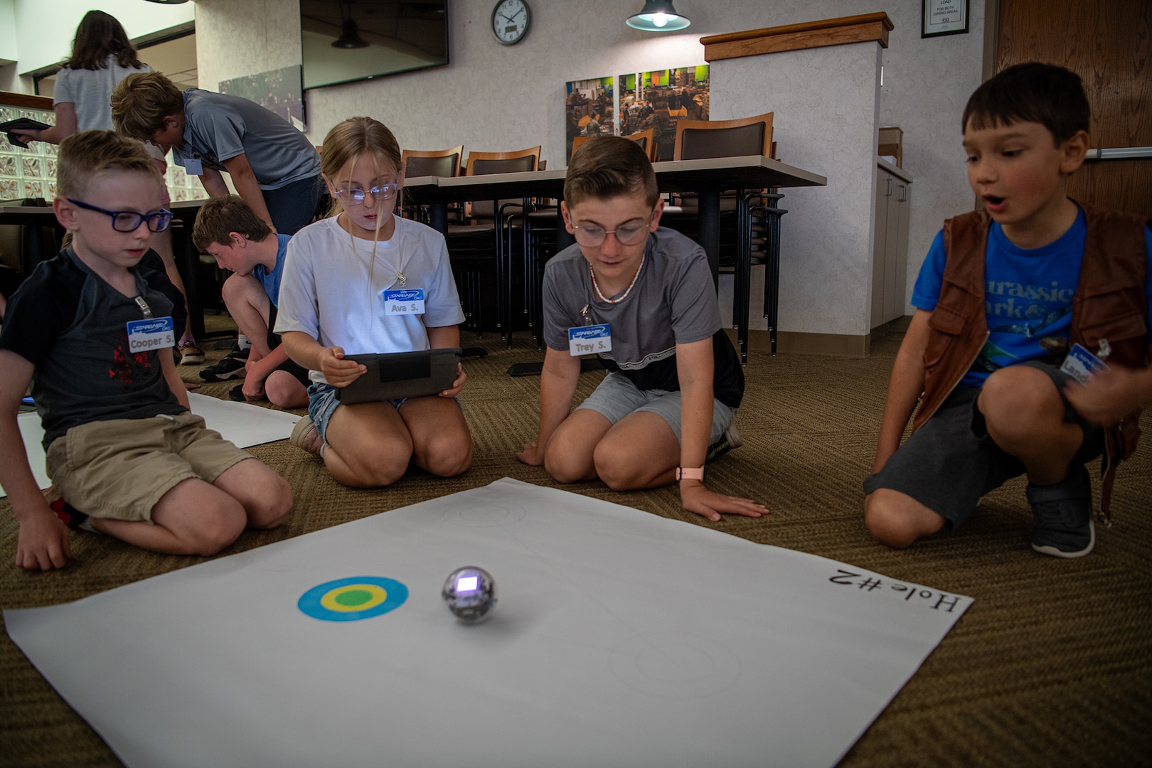 STARBASE Oklahoma City campers watch a small robot they programmed to move to a target location during the STARBASE OKC summer camp at Will Rogers Air National Guard Base in Oklahoma City, June 10, 2024. More than 50 children of Oklahoma National Guard members and Will Rogers Air National Guard base employees attended the camp where they took part in science experiments, built and coded robots to complete simple tasks, learned about computer aided design, and met with National Guard members to hear how STEM education helped propel them on successful careers in the military. (Oklahoma National Guard photo by Anthony Jones)