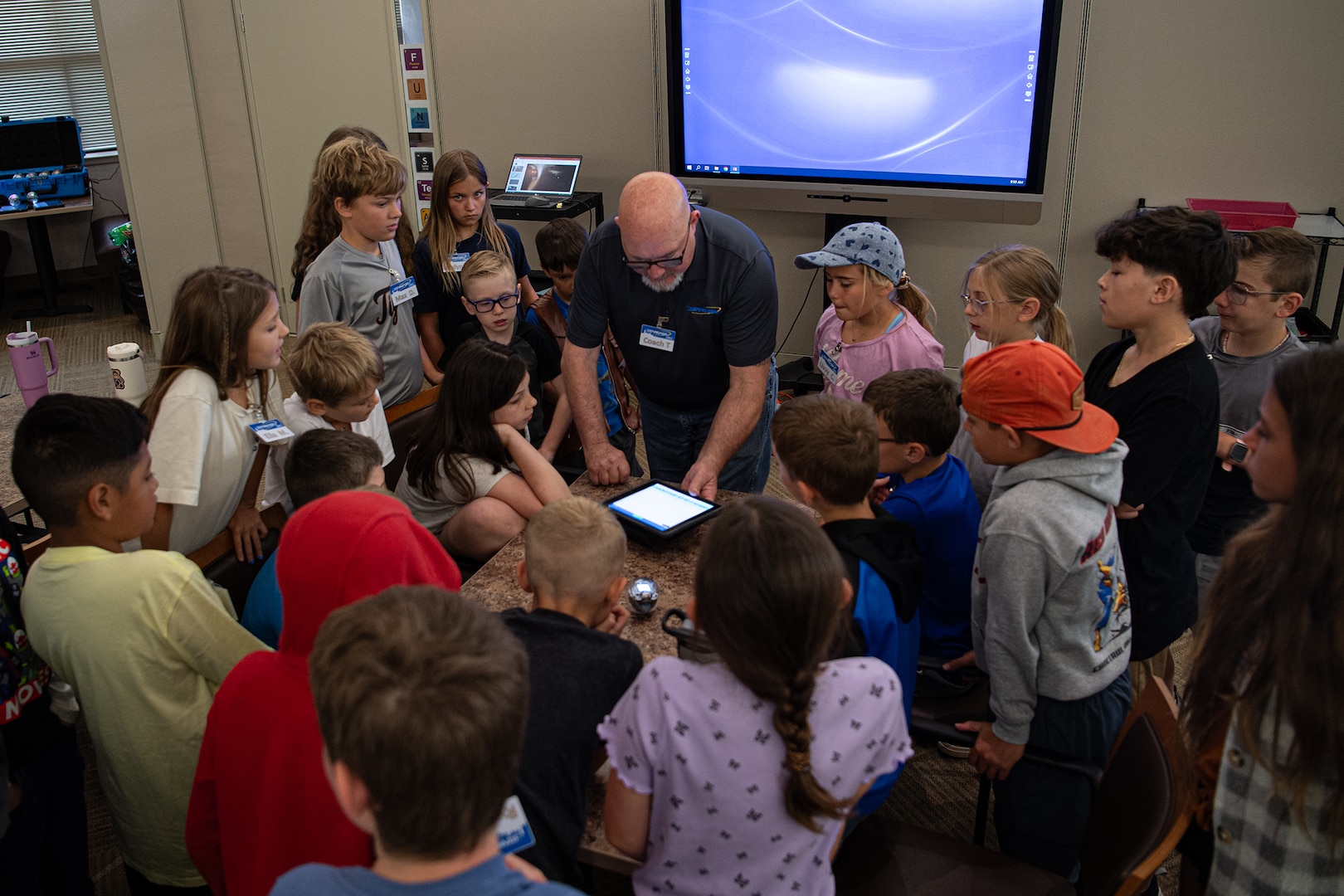 Larry Tettleton, an instructor with STARBASE Oklahoma City, teaches campers how to program a small robot during the STARBASE OKC summer camp at Will Rogers Air National Guard Base in Oklahoma City, June 10, 2024. More than 50 children of Oklahoma National Guard members and Will Rogers Air National Guard base employees attended the camp where they took part in science experiments, built and coded robots to complete simple tasks, learned about computer aided design, and met with National Guard members to hear how STEM education helped propel them on successful careers in the military. (Oklahoma National Guard photo by Anthony Jones)