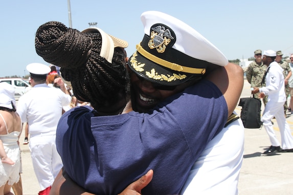 240529-N-GA645-1166 NAVAL STATION ROTA, Spain (May 29, 2024) Cmdr. Tyrchra
Bowman, commanding officer of USS Arleigh Burke (DDG 51), hugs his wife upon return to
Naval Station Rota, May 29, 2024. Arleigh Burke, forward-deployed to Rota, is on a scheduled
patrol in the U.S. Sixth Fleet area of operations in support of U.S. national security interests in
Europe and Africa. (U.S. Navy photo by Courtney Pollock)