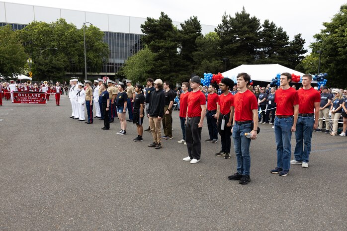 U.S. Marine Corps Col. Michael Ogden, commanding officer of 12th Marine Corps District, administers the Oath of Enlistment to poolees with Recruiting Sub-Station Oregon City, Recruiting Station Portland, and Navy Talent Acquisition Group Portland during the 2024 Grand Floral Parade in Portland, June 8, 2024. The ceremony was held at the beginning of the Grand Floral Parade, an annual event that occurs during the Portland Rose Festival. (U.S. Marine Corps photo by Cpl. Andrew Bray)