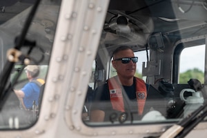 Man Steering Boat
