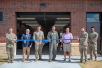 Members of the 628th Logistics Readiness Squadron prepare to cut the ribbon.