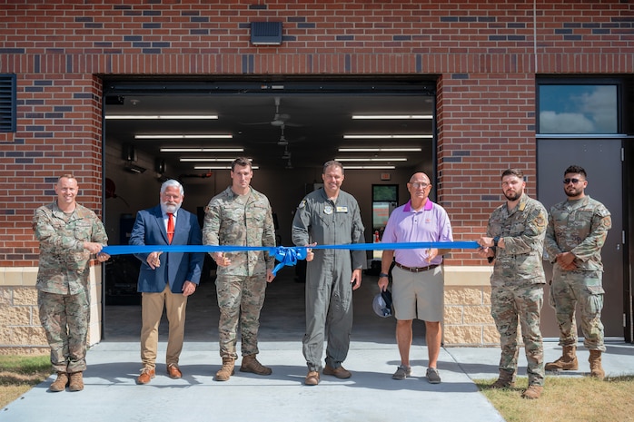 Members of the 628th Logistics Readiness Squadron prepare to cut the ribbon.