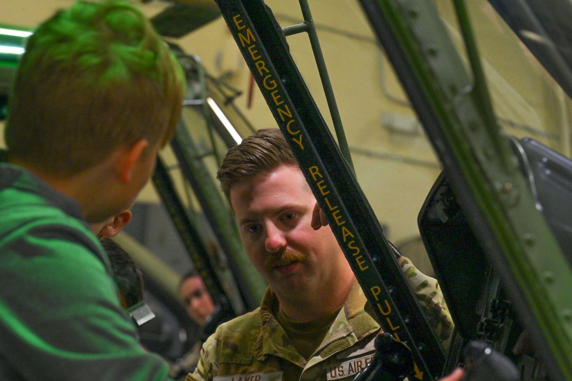 U.S. Air Force Staff Sgt. Jesse Laker, 54th Helicopter Squadron evaluator flight engineer, answers questions during a UH-1N Iroquois helicopter static display tour at Minot Air Force Base, North Dakota, June 10, 2024. The tour was held in support of the STARBASE Program, which supplied students with 25 hours of enriching experiences at more than 80 Air Force, Air Force Reserve, Army, National Guard, Navy, and Space Force bases across the United States, Guam, and Puerto Rico.
