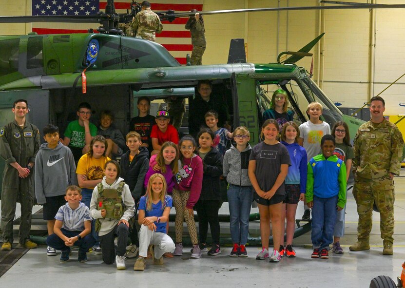 Team Minot Airmen pose for a group photograph with Department of Defense sponsored STARBASE Science, Technology, Engineering, & Math (STEM) summer program students at Minot Air Force Base, North Dakota, June 10, 2024. The program supplied students with 25 hours of enriching experiences at more than 80 Air Force, Air Force Reserve, Army, National Guard, Navy, and Space Force bases across the United States, Guam, and Puerto Rico.