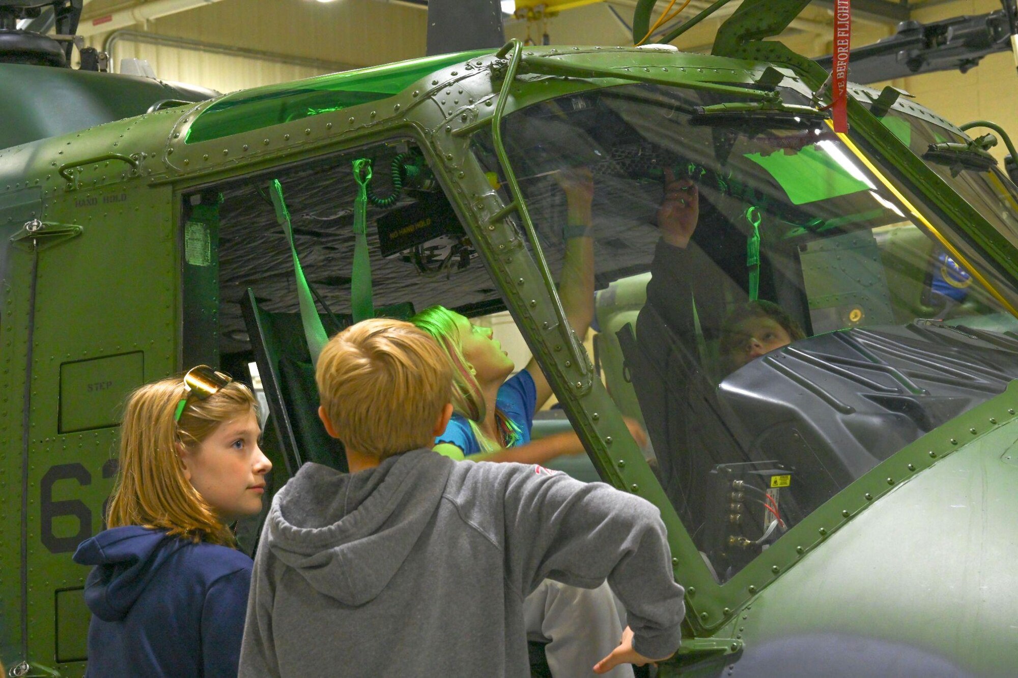 Department of Defense (DoD)-sponsored STARBASE Science, Technology, Engineering, & Math summer program students sit in a UH-1N Iroquois during a helicopter static display tour at Minot Air Force Base, North Dakota, June 10, 2024. The program's goal is to develop a highly educated and skilled American workforce that can meet the advanced technological requirements of the DoD.