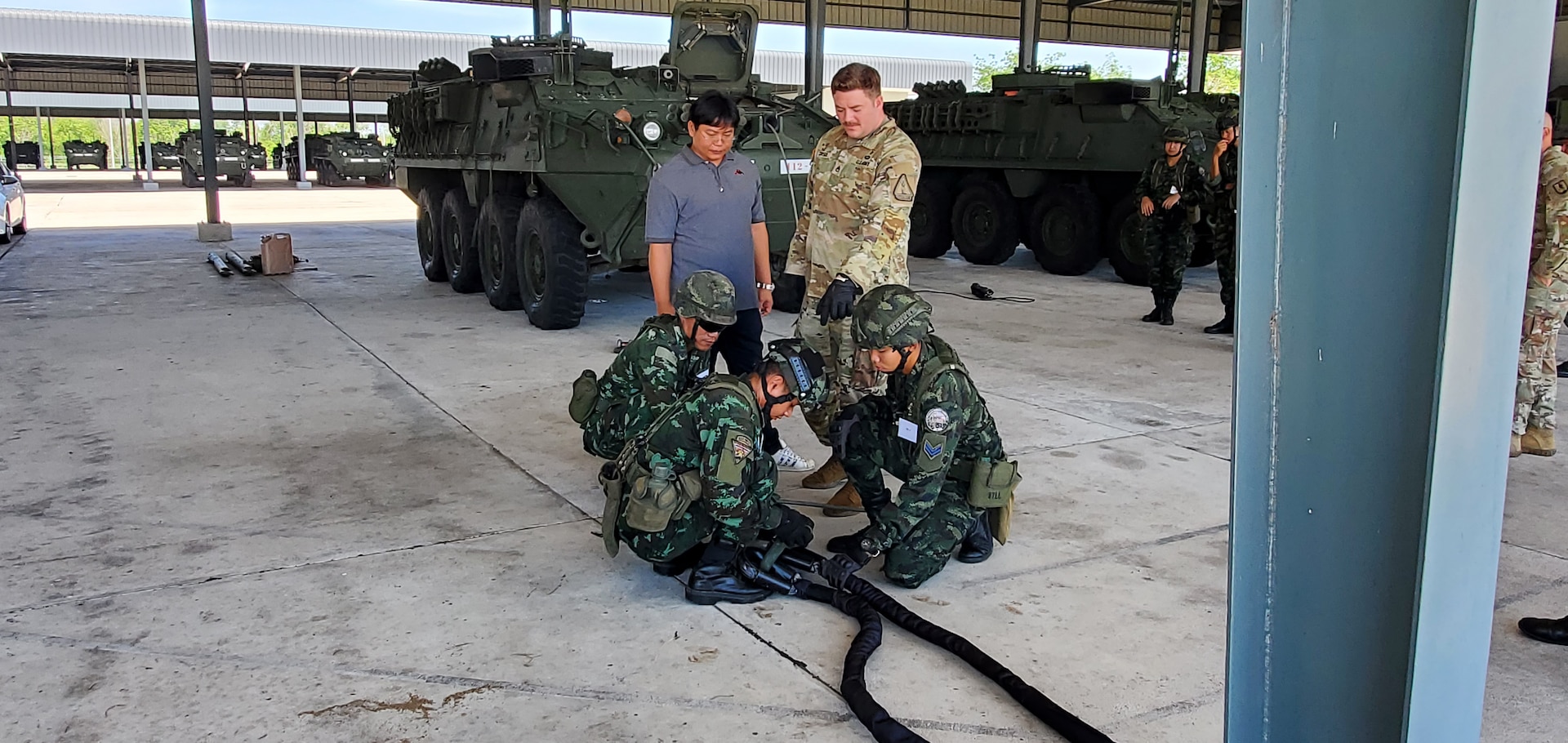 Staff Sgt. Daniel Corser, 1st Battalion, 205th Regimental Training Institute, Washington National Guard, observes members of the 112th Stryker Regiment, Royal Thai Army, while they conduct recovery operations during a Stryker subject matter exchange in Chon Buri, Thailand, May 6-17, 2024.