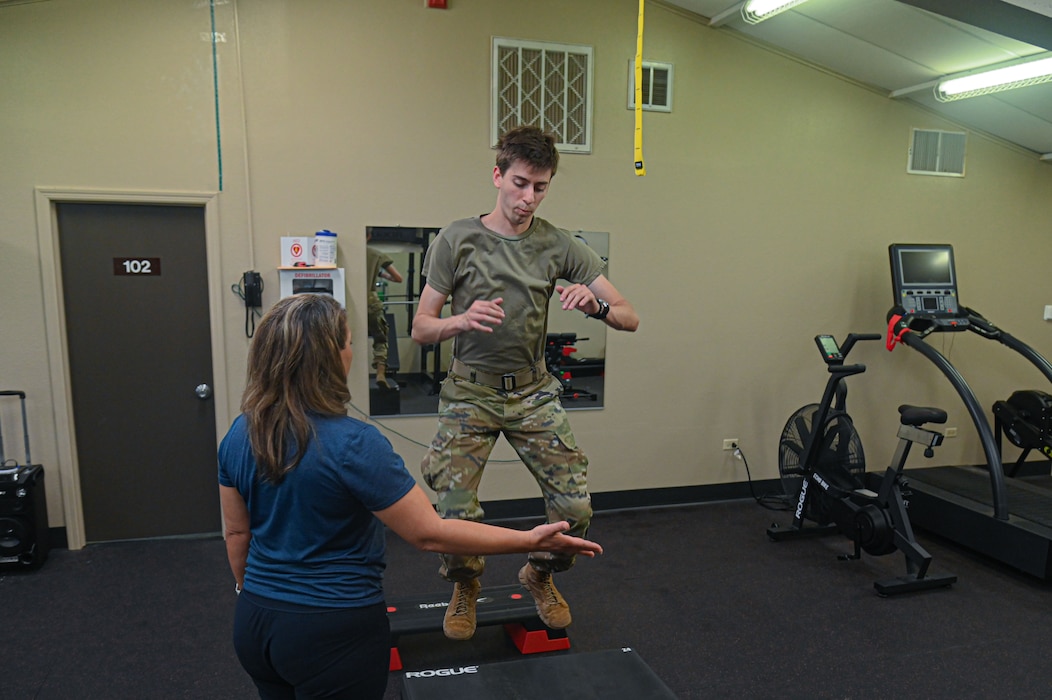 U.S. Air Force Senior Airman Zach Heimbuch, 17th Training Wing public affairs specialist, is coached by Cheri Cotton, Operational Support Teams strength and conditioning coach, exercise physiologist, and nutritionist, on how to execute a proper plyometrics exercise at Goodfellow Air Force Base, Texas, May 30, 2024. OST’s strength and conditioning coach provides different workouts and exercises, run analysis and desk ergonomics analysis to ensure Airmen live and work healthily. (U.S. Air Force photo by Airman 1st Class James Salellas)