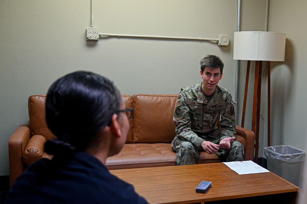 U.S. Air Force Senior Airman Zach Heimbuch, 17th Training Wing public affairs specialist, talks to Lt. Col. Amanda Hardy-Miller, Operational Support Team psychologist, about the role of a mental health provider at Goodfellow Air Force Base, Texas, May 30, 2024. OST establishes relationships with the members they provide care for by shadowing Airmen at work to see their day-to-day lifestyle and how they care for their mental and physical well-being. (U.S. Air Force photo by Airman 1st Class James Salellas)