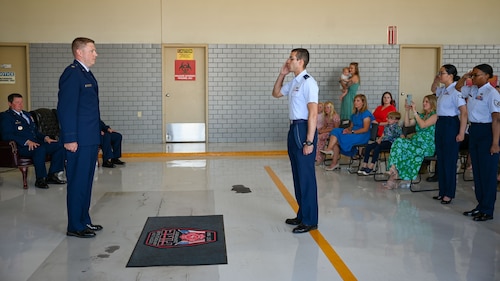 U.S. Air Force Maj. Levi Beard, incoming 17th Civil Engineering Squadron commander, receives his first salute from members of the 17th CES during the 17th CES change of command ceremony at the Goodfellow Fire Department, Goodfellow Air Force Base, Texas, June 13, 2024. The salute represents the squadron welcoming its new commander. (U.S. Air Force photo by Airman 1st Class Evelyn J. D’Errico)