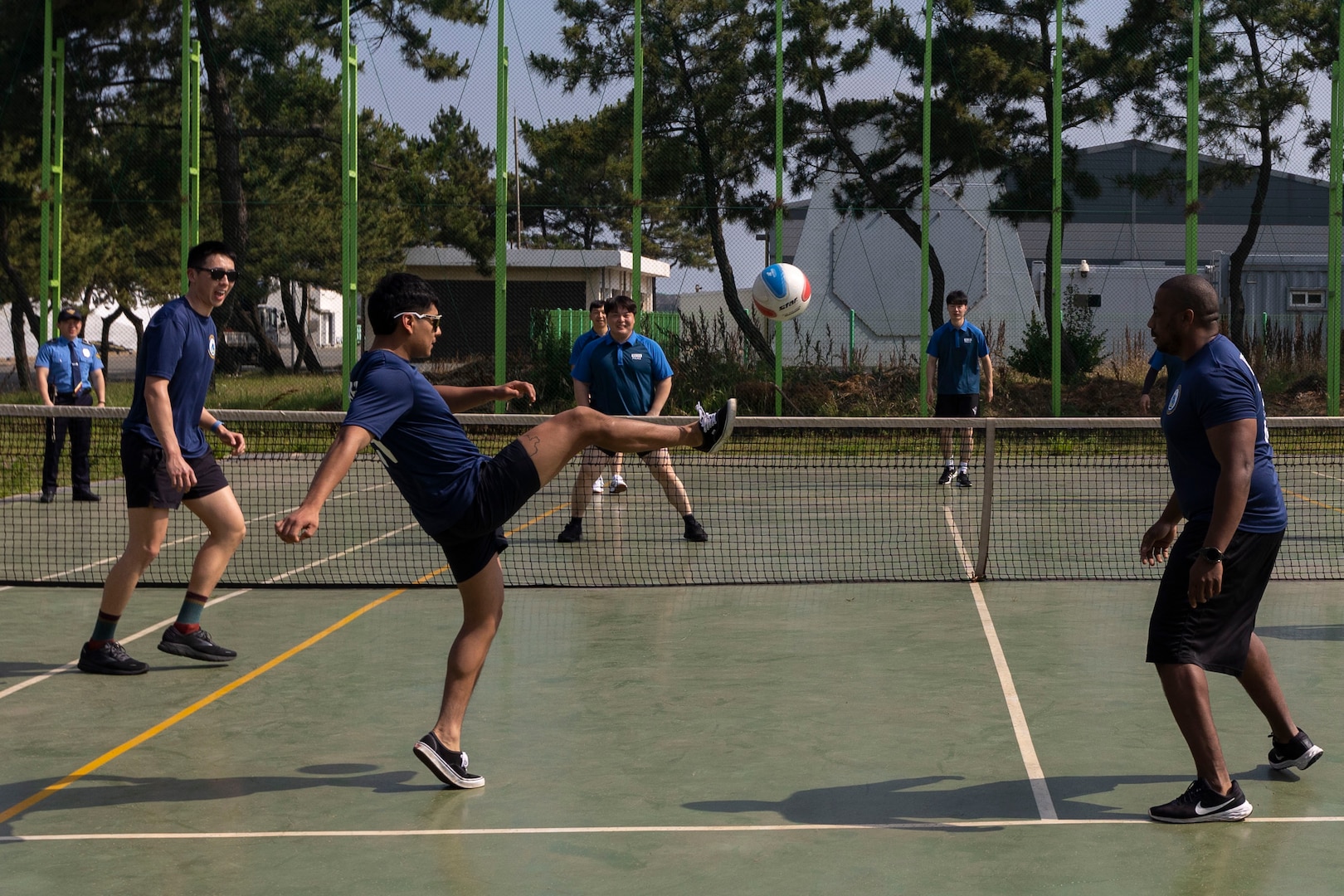 U.S. Coast Guardsmen assigned to the U.S. Coast Guard Cutter Waesche (WMSL-751) and members of the Korea Coast Guard play a game of jokgu during a sports day in Pohang, Republic of Korea, June 10, 2024. Korea Coast Guardsmen explained the rules and demonstrated how to play jokgu to United States Coast Guardsmen before participating in a friendly competition. The U.S. Coast Guard has operated in the Indo-Pacific for more than 150 years, and the service is increasing efforts through targeted patrols with our National Security Cutters, Fast Response Cutters and other activities in support of Coast Guard missions to enhance our partnership. (U.S. Marine Corps photo by Cpl. Elijah Murphy)