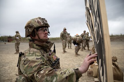U.S. Army Staff Sgt. Derrek King, assigned to the 3rd Battalion, 509th Parachute Infantry Regiment, examines his shot target after firing the M17 Modular Handgun System during The Adjutant General’s Match at Joint Base Elmendorf-Richardson, Alaska, May 21, 2024.