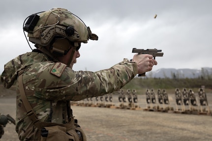 Alaska Air National Guard Capt. Matthew Swanson, a HH-60G Pave Hawk pilot assigned to the 210th Rescue Squadron, fires the M18 Modular Handgun System while competing in The Adjutant General’s Match at Joint Base Elmendorf-Richardson, Alaska, May 21, 2024.