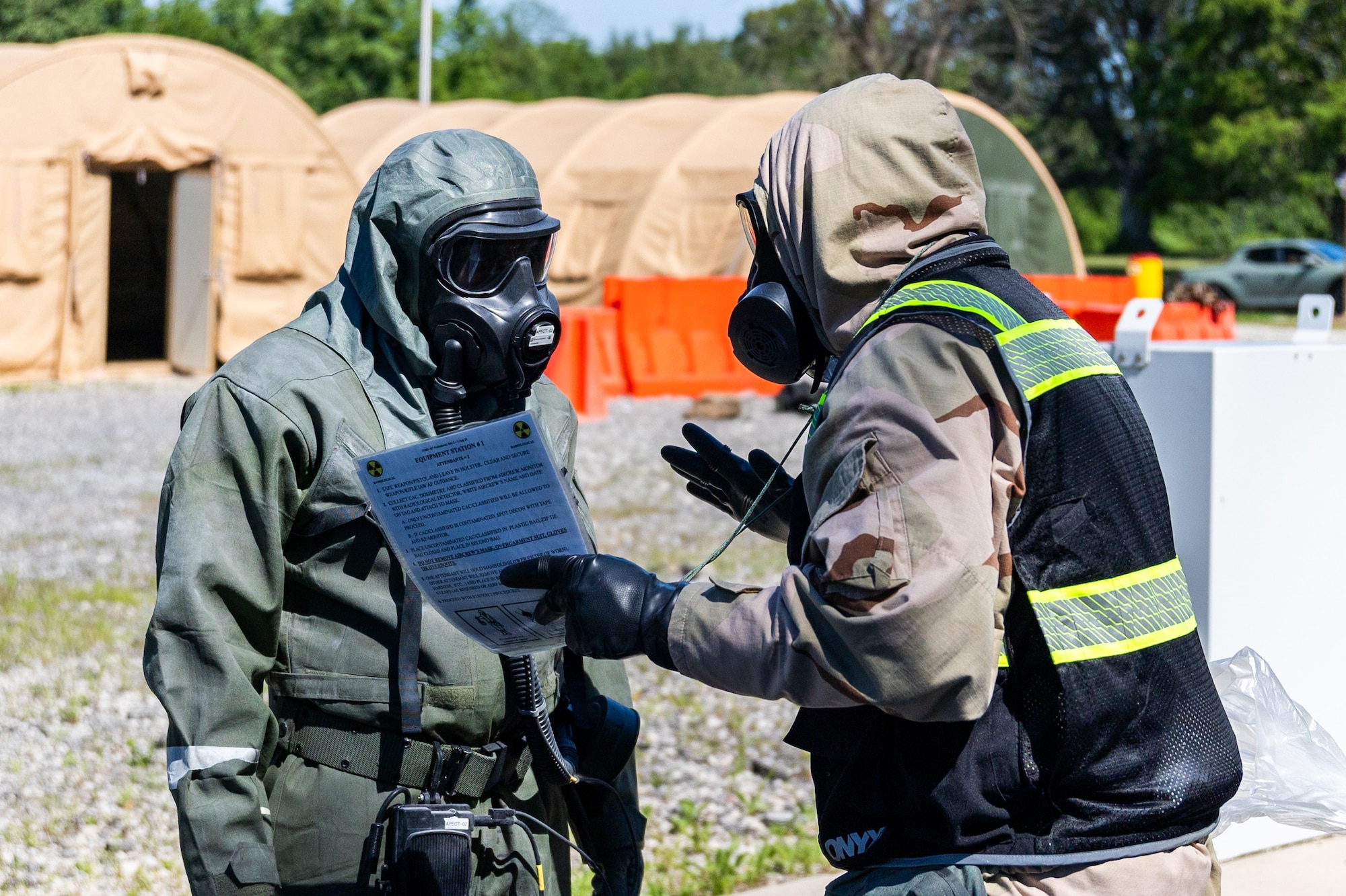 Aircrew Flight Equipment trainees participate in a chemical decontamination exercise during Toxic Arch at Scott AFB, Ill. June 13, 2024. Toxic exercises are held annually by different commands within the Air Force, they allow AFE Airmen to train for real-world decontamination scenarios. (U.S. Air Force Photo by Chris Bishop)