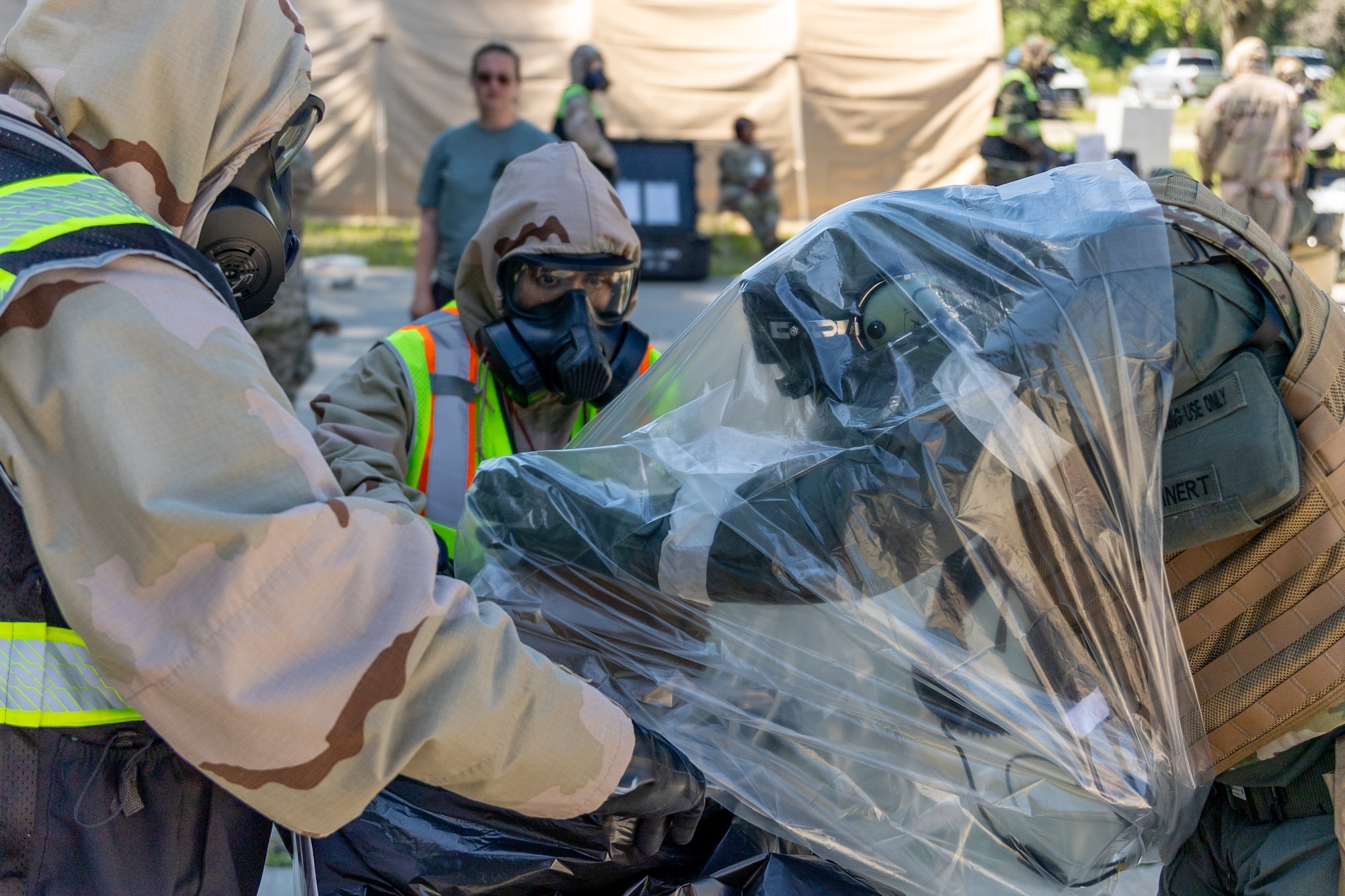 Aircrew Flight Equipment Airmen participate in decontamination exercises at Scott AFB, Ill. June 13, 2024. Toxic exercises are held annually by different commands within the Air Force, they allow AFE Airmen to train for real-world decontamination scenarios. (U.S. Air Force Photo by Chris Bishop)