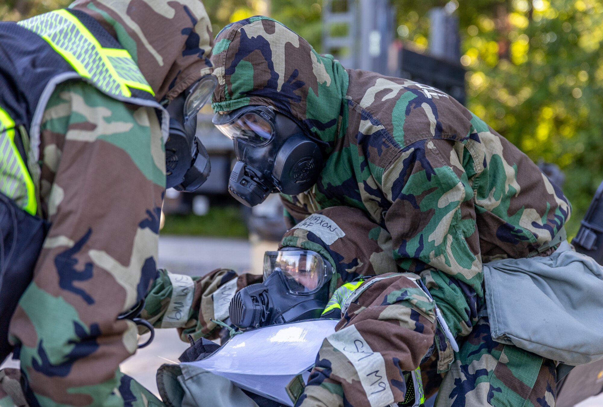 Aircrew Flight Equipment Airmen participate in decontamination exercises at Scott AFB, Ill. June 13, 2024. Toxic exercises are held annually by different commands within the Air Force, they allow AFE Airmen to train for real-world decontamination scenarios. (U.S. Air Force Photo by Chris Bishop)