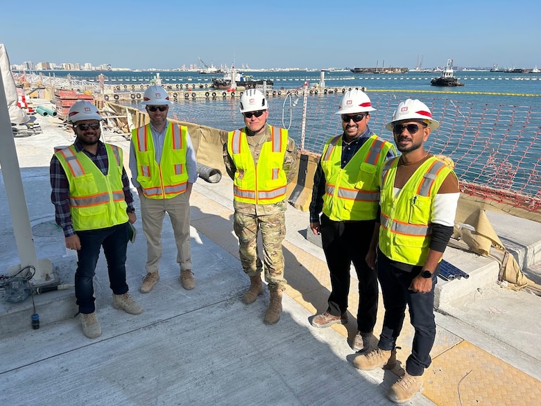 A group of men in PPE at a TAM project site.