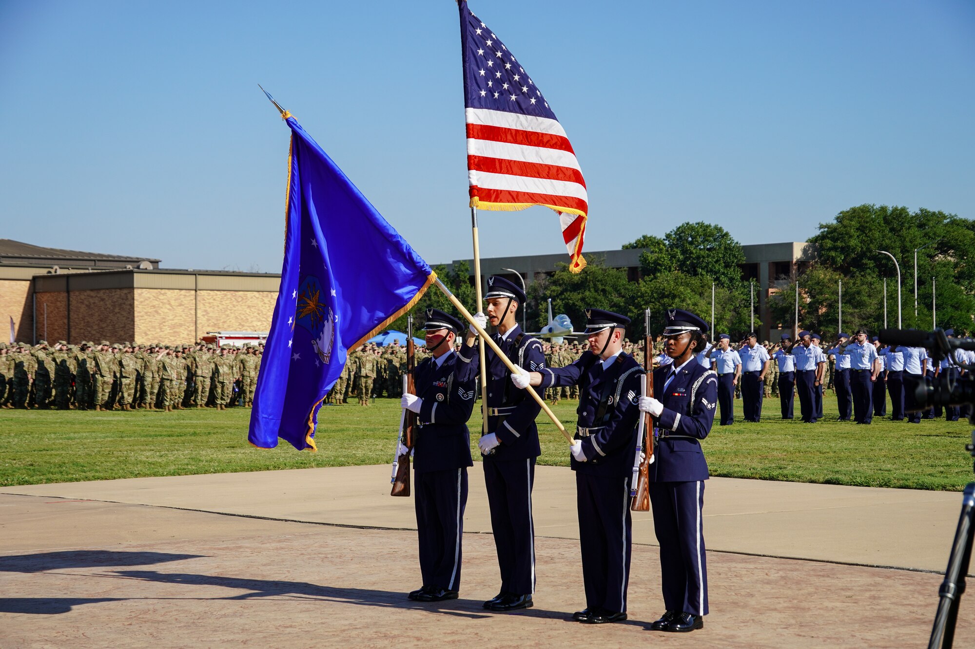 An Air Force Honor Guard stands with flags
