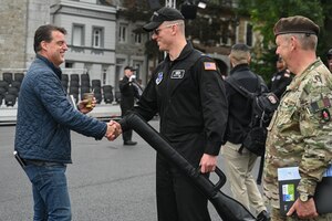 U.S. Air Force 1st Lt Andrew R. Paquin, center, Honor Guard officer in charge of ceremonial operations, is greeted by Patrick De Smet, producer for the Belgian Defence International Tattoo 2024, at Kriegerdenkmal square in Eupen, Belgium, June 3, 2024.