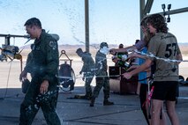 Pilot getting sprayed with champagne by his family