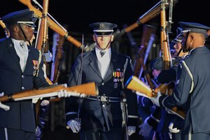 U.S. Air Force 1st Lt Andrew R. Paquin, Honor Guard officer in charge of ceremonial operations, walks through a gauntlet of spinning weapons performed by the U.S. Air Force Honor Guard Drill Team at the Belgian Defence International Tattoo 2024 in Tournai, Belgium, June 7, 2024.