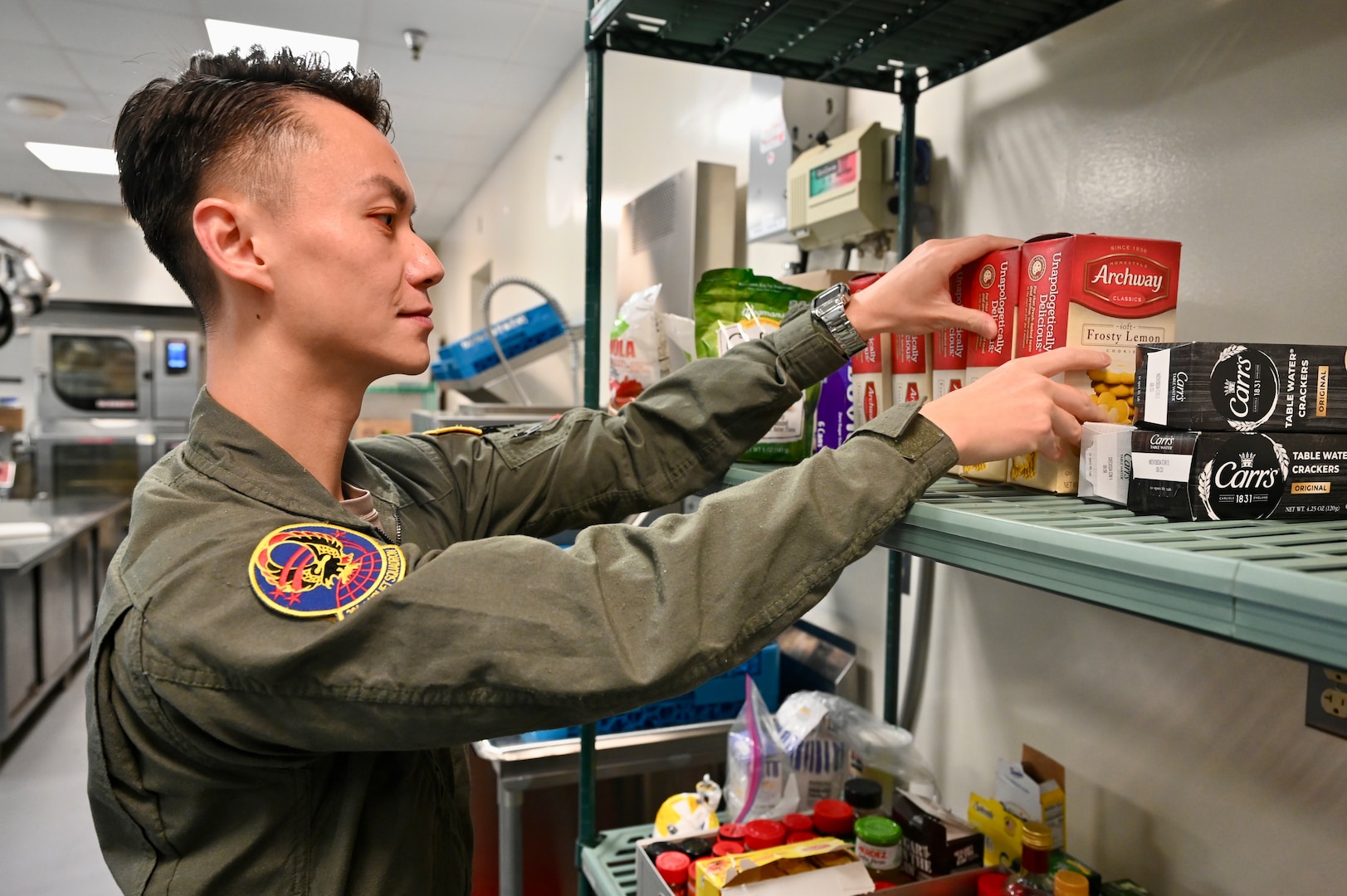 Tech. Sgt. Lang Xiao, flight attendant, D.C. Air National Guard, organizes items prior to a Congressional transport at Joint Base Andrews, Md., May 19, 2024. The former communication designer embraces the challenge each new mission brings as a D.C. Air National Guard flight attendant to include a strong a desire for international travel.