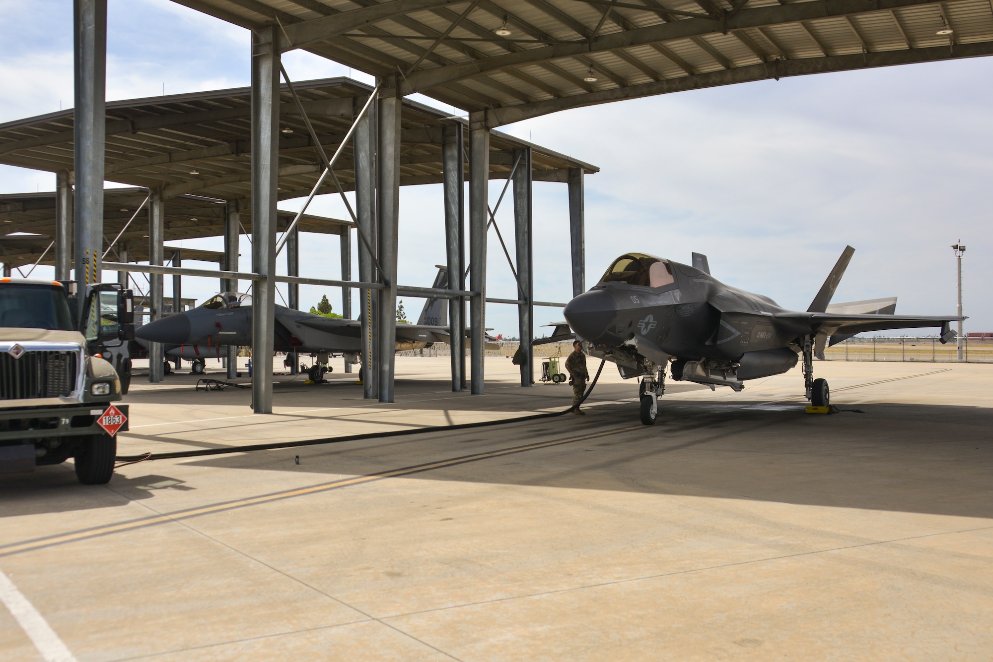 An F-35B Lightning II is refueled on the flightline of the Fresno Air National Guard Base, California, while parked next to an F-15C Eagle, June 8, 2024.