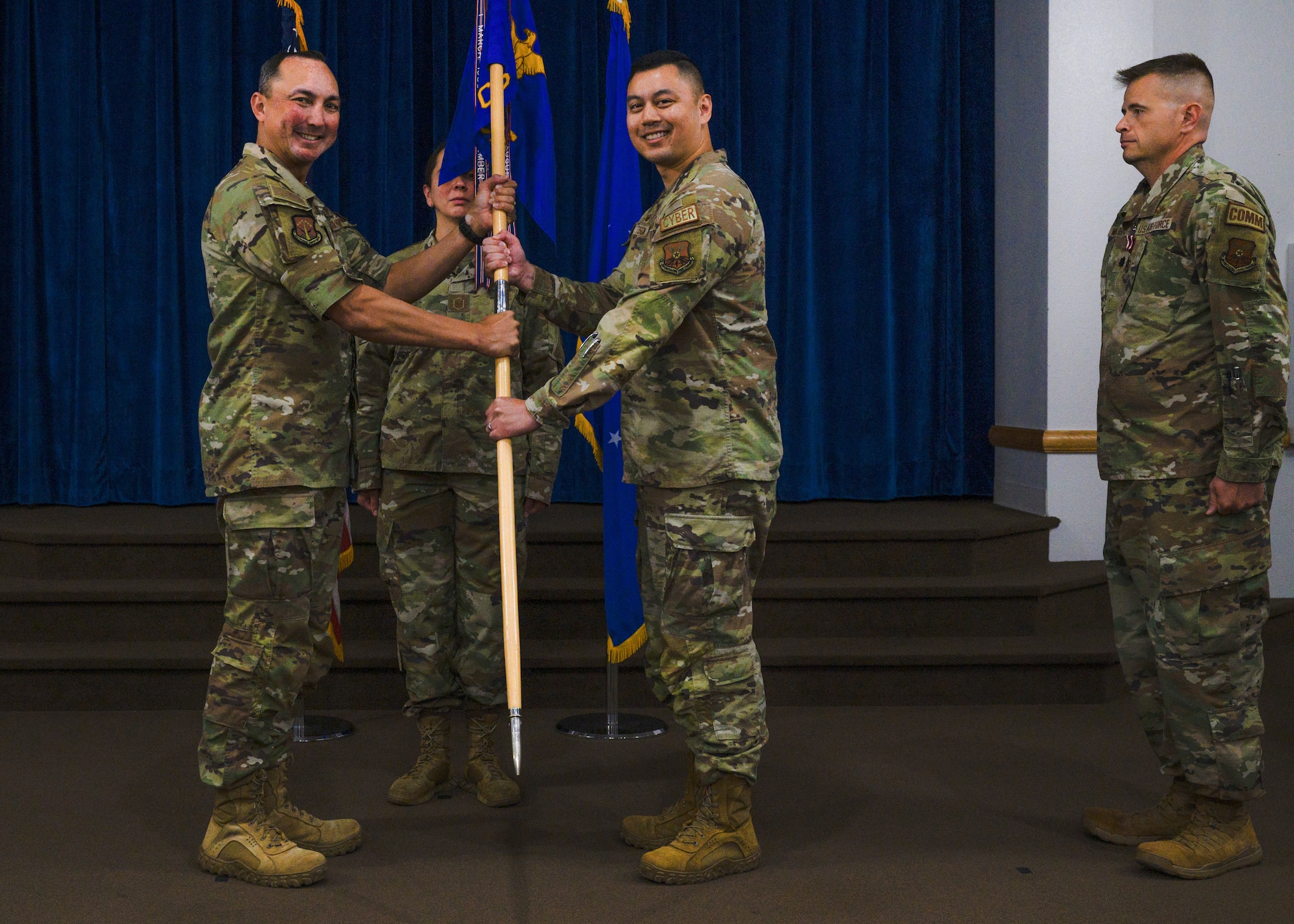 military members passing a guidon flag