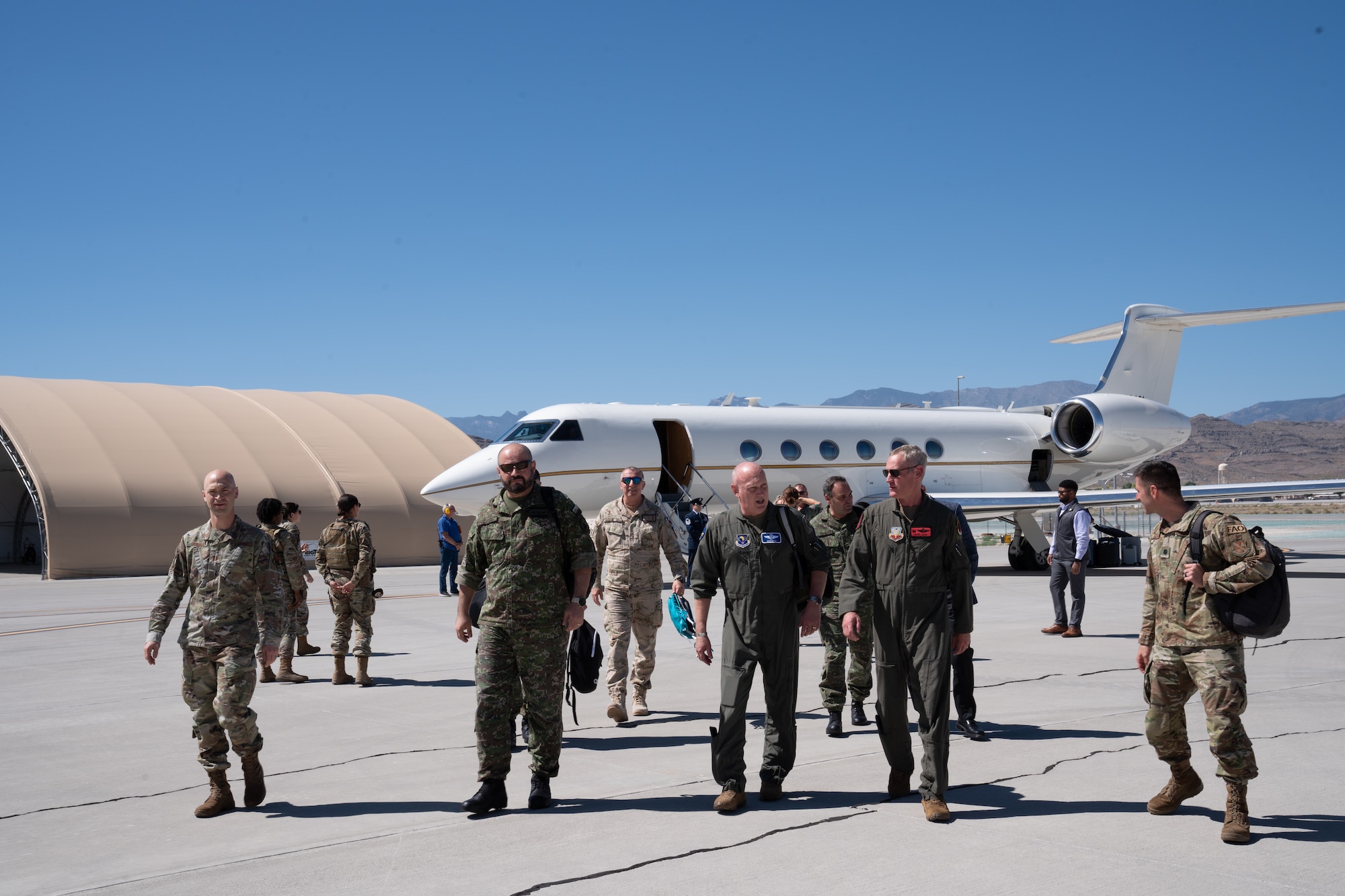 A group of people in military uniforms pose for a photo.