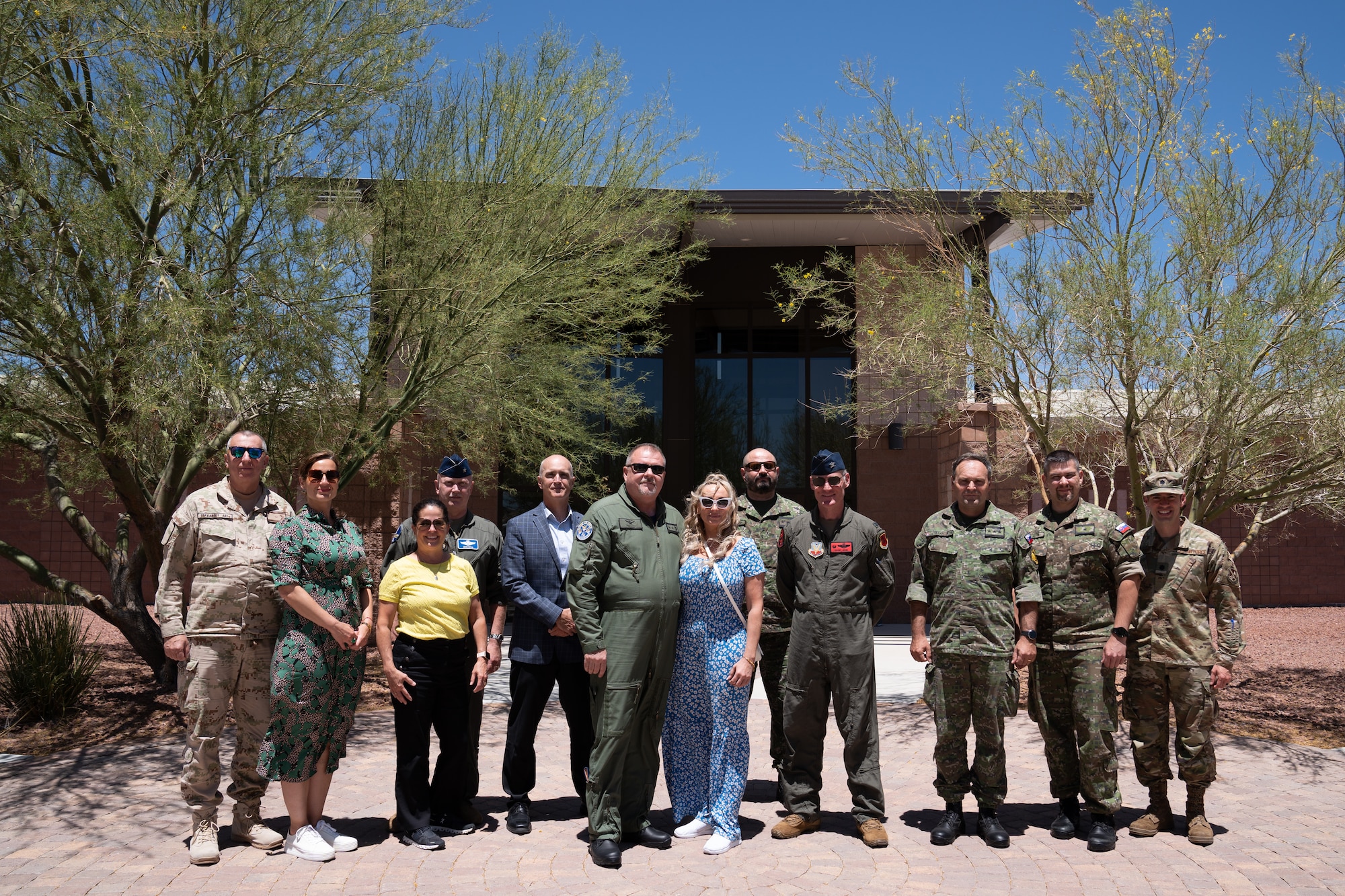 A group of people in military uniforms pose for a photo.