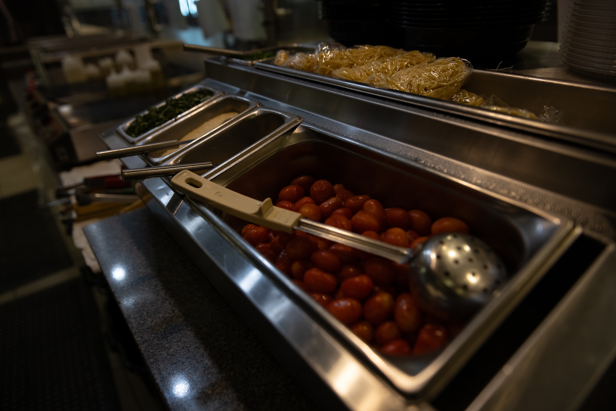 Italian ingredients rest in trays.