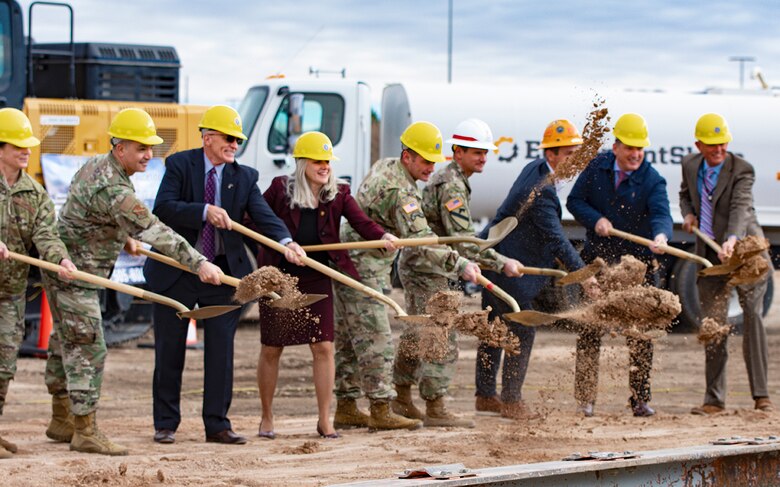 Albuquerque District commander Lt. Col. Pat Stevens (4th from right in white hat), joins the Defense Threat Reduction Agency's Director of Acquisition, Finance, and Logistics, Lisa Swan, and other dignitaries in the ceremonial earth turning to mark the beginning of construction on a much-needed DTRA administrative building, Dec. 9, 2021, at Kirtland Air Force Base, N.M.