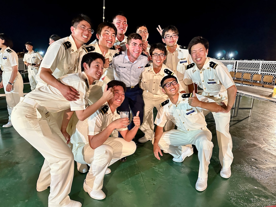 U.S. Coast Guard Cadet Allentuck takes a moment for a photo with cadets aboard the Japanese Coast Guard training ship Kojima during their visit to Guam on June 12, 2024. During the visit, three U.S. Coast Guard Academy cadets had the unique opportunity to share their recent experience of joining their Japanese counterparts on the voyage to Guam. This journey created lasting memories and built strong professional relationships. (U.S. Coast Guard photo by Chief Warrant Officer Sara Muir)