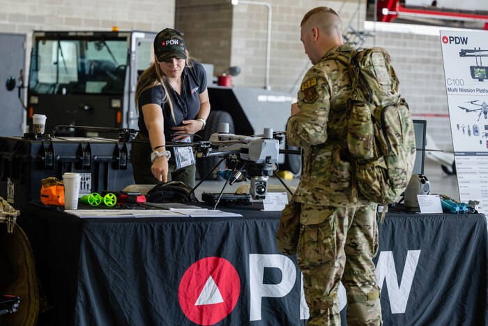 Civilian talks to Airman.