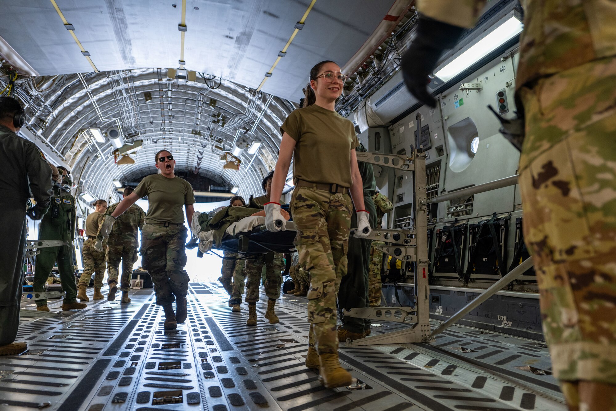 U.S. Air Force Airman walk onto a plane.