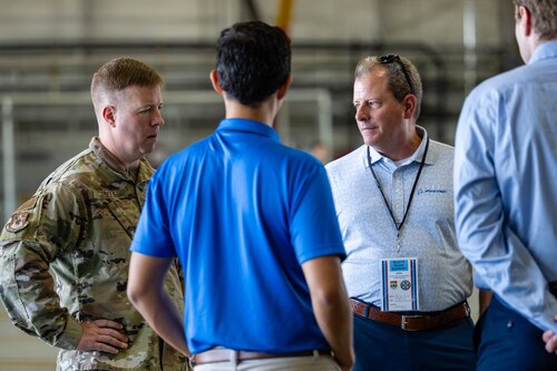 Airman talks to civilians.