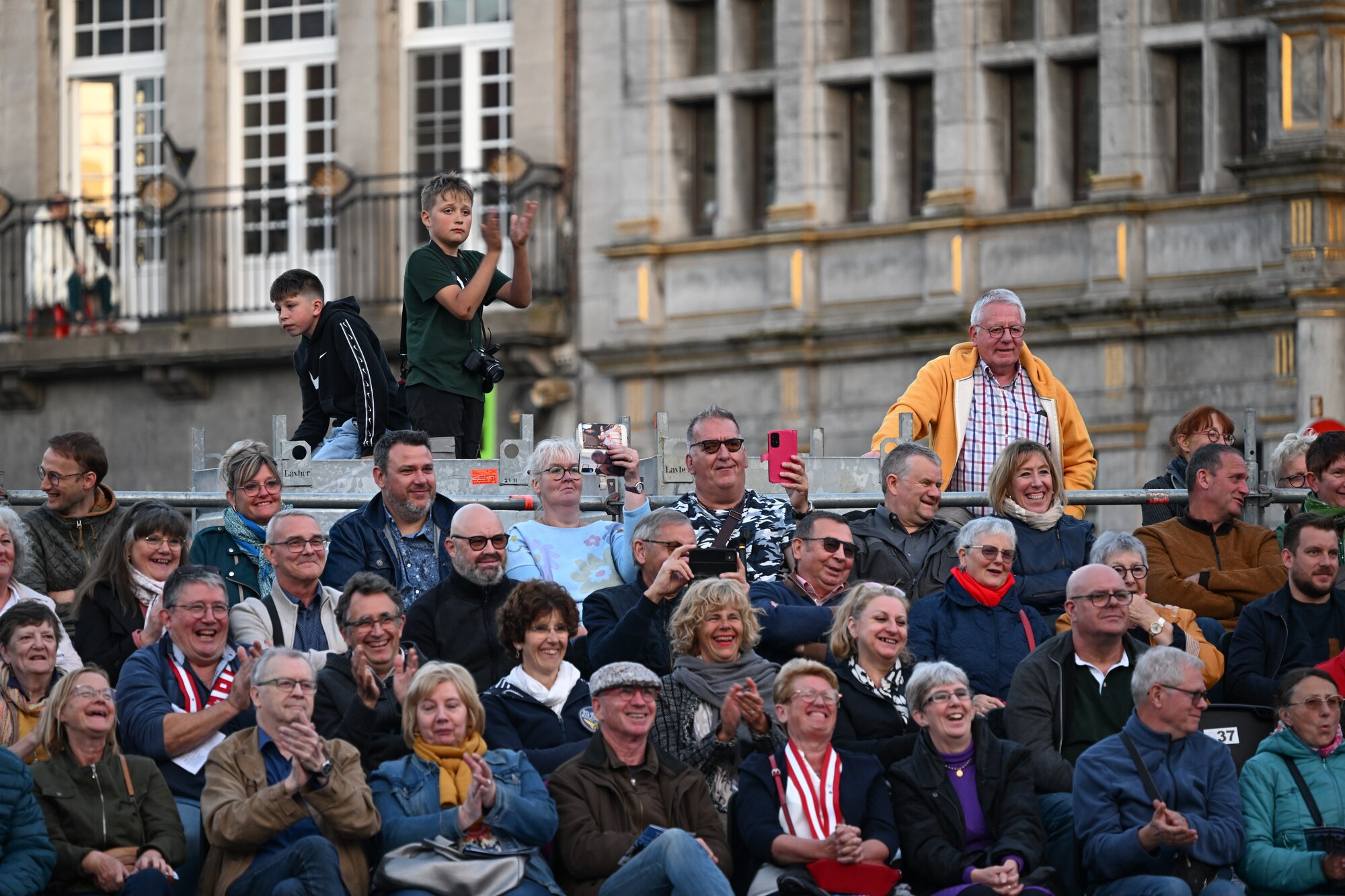 The audience at the Belgian Defence International Tattoo 2024 cheers during a performance at the Grand Place at Tournai, Belgium, June 7, 2024.