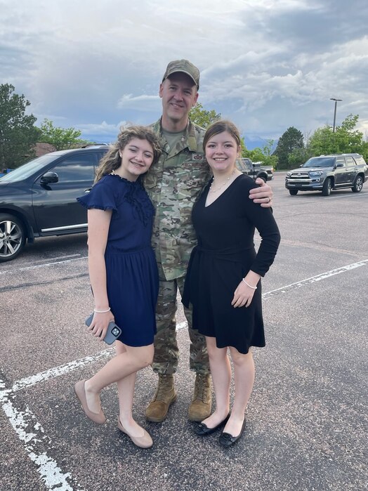  U.S. Air Force Master Sgt. Thomas Hallanger stands with his family and poses for a photo.