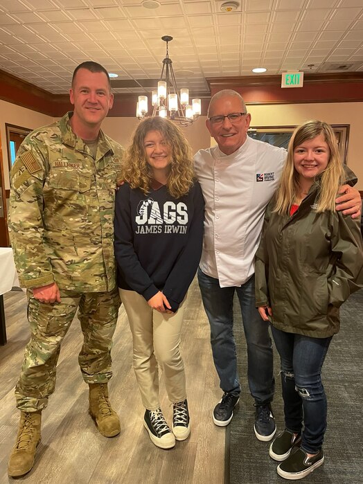  U.S. Air Force Master Sgt. Thomas Hallanger stands with his family and poses for a photo.