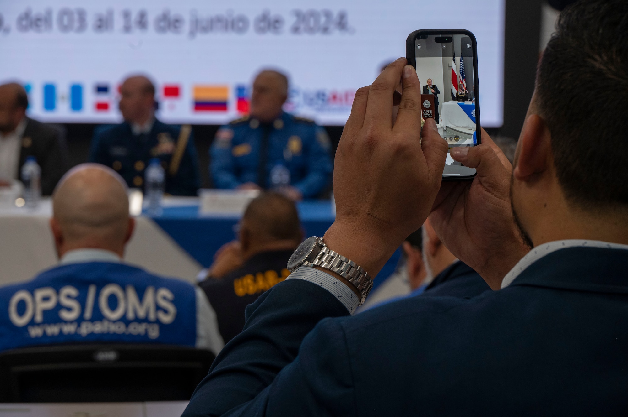 A photo of a person holding a phone and taking a picture.